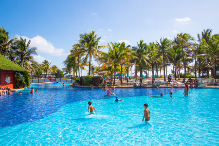 Mexico, Cancun - February 15, 2018: Grand Pyramid entertaining complex. Grand Oasis hotel swimming pool with people and kids playing in waterのeditorial素材