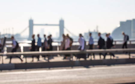 London, UK. Blurred image of office workers crossing the London bridge in early morning on the way to the City of London. Tower bridge at the background. Rush hoursの写真素材