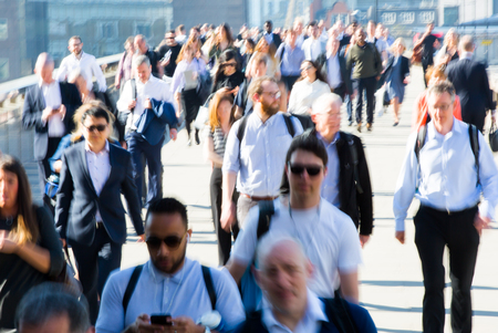 London, UK - April 19, 2018: Blurred image of office workers crossing the London bridge in early morning on the way to the City of London, the leading business and financial area in Europe. Rush hoursのeditorial素材