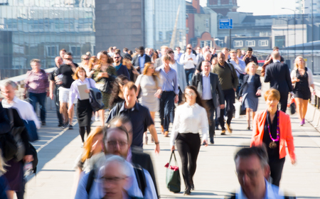 London, UK - April 19, 2018: Blurred image of office workers crossing the London bridge in early morning on the way to the City of London, the leading business and financial area in Europe. Rush hoursのeditorial素材