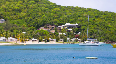 Antigua, Caribbean islands, English Harbour - May 20, 2017: English harbour view with Freeman's bay and yachts anchored by the beachのeditorial素材
