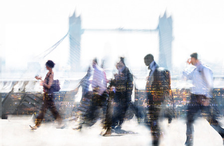 Group of business people walking over London bridge to the City of London. Early morning rush, modern life conceptのeditorial素材
