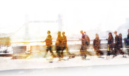 Group of business people walking over London bridge to the City of London. Early morning rush,...