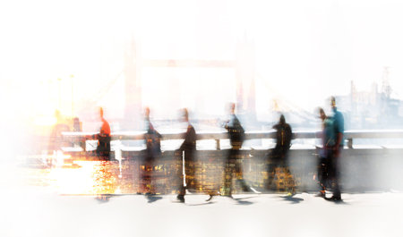 Blurred image of office workers crossing the London bridge in early morning on the way to the City...
