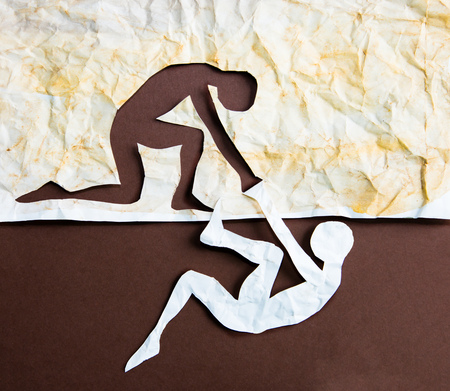 Abstract people helping to get out of problems. Paper cut compositionの写真素材