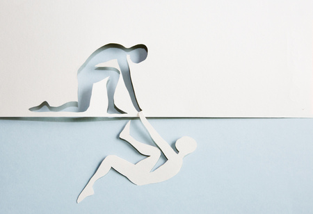 Abstract people helping to get out of problems. Paper cut compositionの写真素材