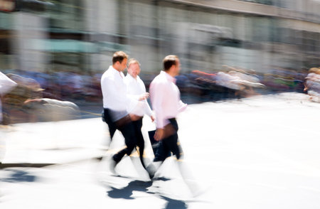 Walking people motion blur. City of London busy business life. People crossing the road