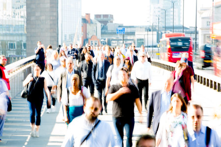 London, UK - 20 April, 2018: City of London  with lots of commuters crossing the bridge on the way to work. Early morning hours in Londonのeditorial素材
