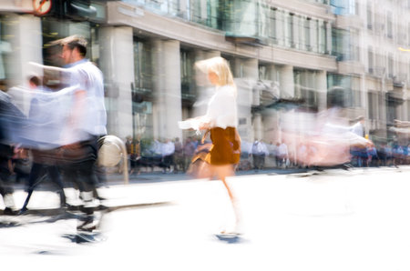 Walking people motion blur. City of London busy business life. People crossing the road