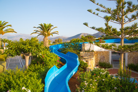Hersonissos, Crete, Greece- July 17, 2018: Water slide in 5 stars Aldemar Knossos Royal Hotel with village-style layout, surrounded by beautiful gardenのeditorial素材