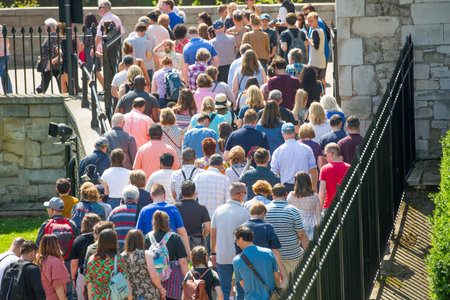 London, UK - April 19, 2018: Lots of people crossing the footbridge near Tower of London. Rush hours...