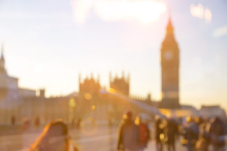London, UK - November 30, 2016: Westminster bridge at sunset with people and transport crossing the...
