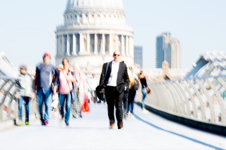 London, UK - April 19, 2018: Blurred image of office workers crossing the Millennium bridgeのeditorial素材