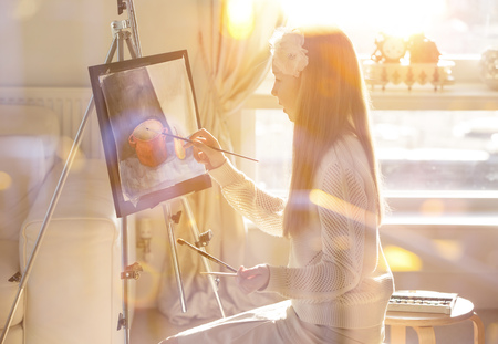 Little girl painting still-life agains of sunlight. Education conceptの写真素材
