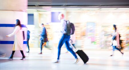 Beautiful motion blur of walking people. Early morning rush hours, busy modern life concept. Ideal for websites and magazines layoutsの写真素材