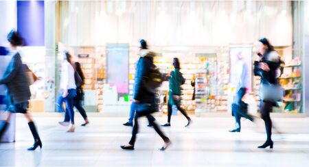 Beautiful motion blur of walking people. Early morning rush hours, busy modern life concept. Ideal for websites and magazines layoutsの写真素材