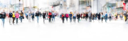 Panoramic blurred background with lots of people, office workers and tourists walking in the Leicester square, London. Busy life concept, business and travel.の写真素材