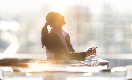 Portrait of business woman working in office by the desk. Business concept, work in progress, achievement and support.の写真素材