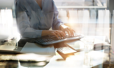 Young business woman working in office by the desk. Business concept, work in progress, achievement...