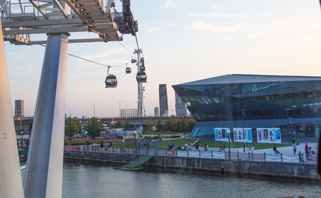 London, UK - August 27, 2019: Cable cars  above London. View includes Excel exhibition complex, docks and river Thames at sunset.のeditorial素材