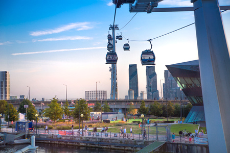 London, UK - August 27, 2019: Cable cars  above London. View includes Excel exhibition complex, docks and river Thames at sunset.のeditorial素材