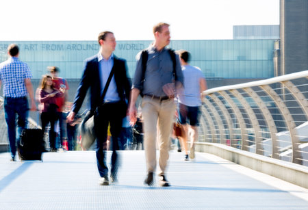 London, UK - April 19, 2018: Motion blur of business people walking in the City of London.