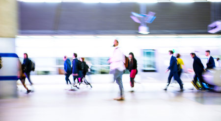 Motion blur of walking people. People on the way to work, rushing through the underground tunnel. London, UKの写真素材