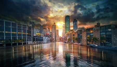 Canary Wharf view at sunset. Business area, banks and office buildings at the distance with beautiful reflection in the water. London, UKの写真素材
