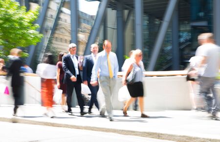 Business people walking in the City of London. Blurred image of the road with people at sunny day. London, UKの写真素材