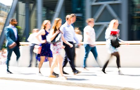Business people walking in the City of London. Blurred image of the road with people at sunny day. London, UKの写真素材