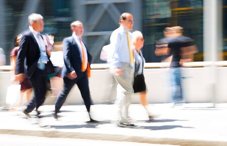People walking in the City of London. Blurred image of the road with people at sunny day. London, UKの写真素材