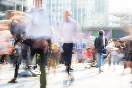 Beautiful background with motion blur people. People walking in the  City of London in early morning. People rushing to work. London, UKの写真素材