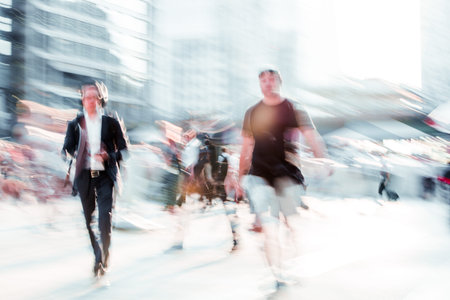 Beautiful background with motion blur people. People walking in the  City of London in early...