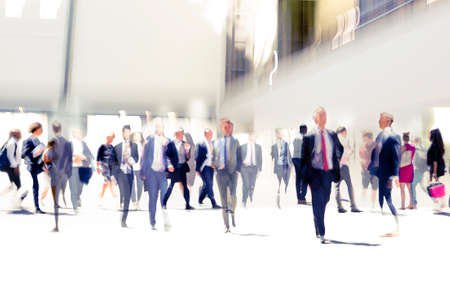 Lots of business people walking in big open space, transport station, airport etc. Blurred image, wide panoramic view with people at rush time. London, UKの写真素材