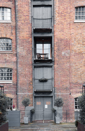London, UK - February 2, 2021: Canary Wharf, facade of old ware houses, nowadays has transferred to...