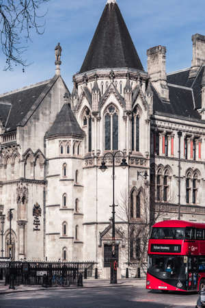 London, UK - February 23, 2021: Royal Courts of Justice. Built in the 1870s and opened by Queen Victoria in 1882. One of the largest courts in Europe. Facade architectural detail.のeditorial素材