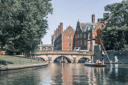 Cambridge, UK - July 16, 2021: River Cam and Punting boat with tourists relaxing and enjoying the views of Cambridge university's collegesのeditorial素材