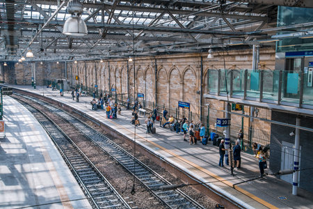 Scotland, Edinburg - August 23, 2021: Edinburg central train station. People waiting boarding at the platformのeditorial素材
