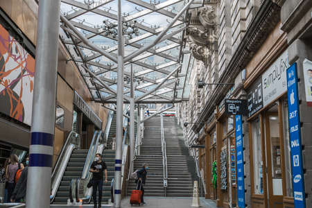 Scotland, Edinburg - August 23, 2021: Stairs and escalator of  Edinburg central train station.のeditorial素材