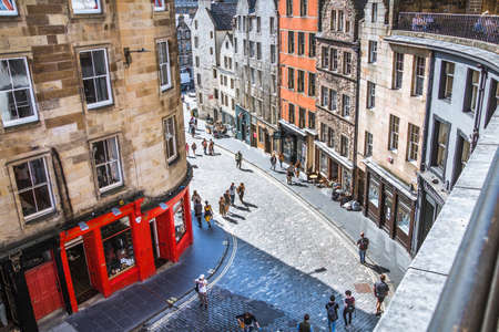 Scotland, Edinburg - August 24, 2021: W Bow slopping road of 19th century with colourful shopfronts and lots of people and tourists walking and admiring the siteのeditorial素材