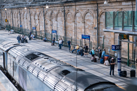 Scotland, Edinburg - August 23, 2021: Edinburg central train station. People waiting boarding at the...