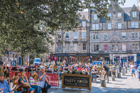 Scotland, Edinburg - August 24, 2021: Grassmarket street, The historic market place and an event space in the Old Town. Lots cafes and restaurants with people relaxing in a hot dayのeditorial素材