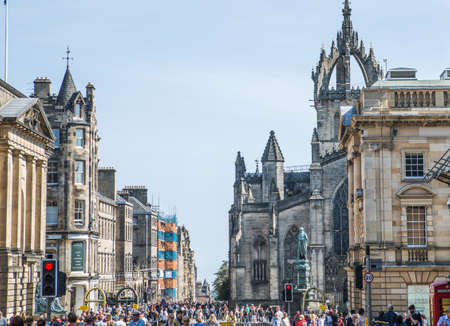 United Kingdom, Edinburg - 24 August, 2021: Royal Mile the Main Street of Edinburgh leads from Castle to the Royal palace and Edinburgh cathedral view. Lots of people walking on the streetのeditorial素材