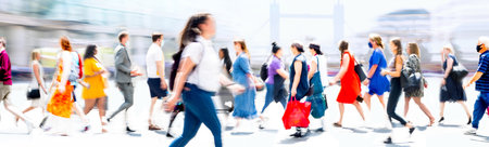 Lots of walking people, multiple exposure illustration represents modern life the big busy city. Business people, young people, students crossing the roadの写真素材