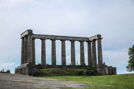 Edinburg, UK - August 23, 2021: Edinburg view from Calton hill. View include Edinburg castle, Balmoral hotel tower, Dugald Stewart Monument and people relaxing in Claton hillのeditorial素材