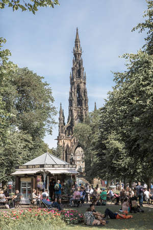 Edinburg, UK - August 23, 2021: Scott monument view form park and lots of people having a rest in cafeのeditorial素材