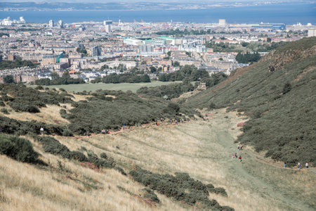 Scotland, Edinburgh, UK - August 26, 2021: Holyrood park and ancient volcano. City of Edinburgh view from the mountainのeditorial素材