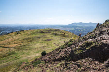 Scotland, Edinburgh, UK - August 26, 2021: Holyrood park and ancient volcano. City of Edinburgh view from the mountainのeditorial素材