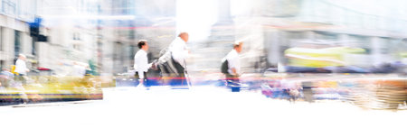 Lots of people walking on the city street. Blurred long time exposure image representing busy life of the big modern capitalの写真素材
