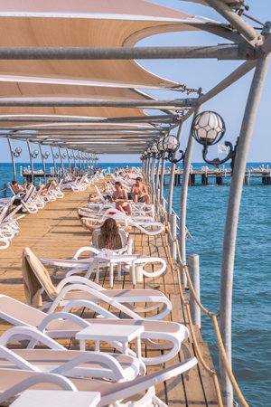 Turkey, Antalya, Lara beach - July 9, 2022: Sun-beds and umbrellas on the Lara beachのeditorial素材